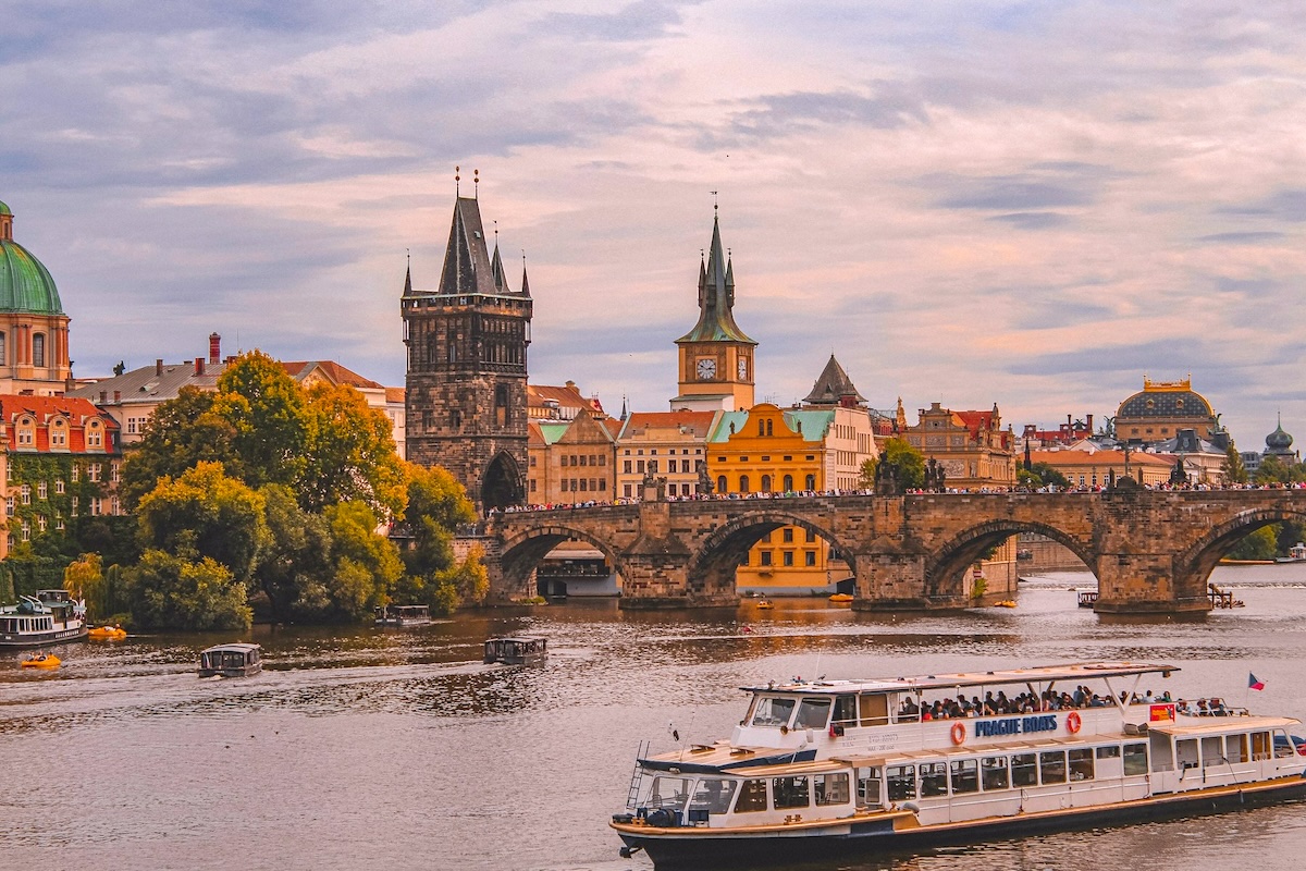 Tour boat sailing past Charles Bridge in Prague