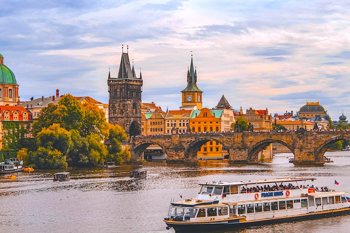 Tour boat sailing by the Charles Bridge in Prague
